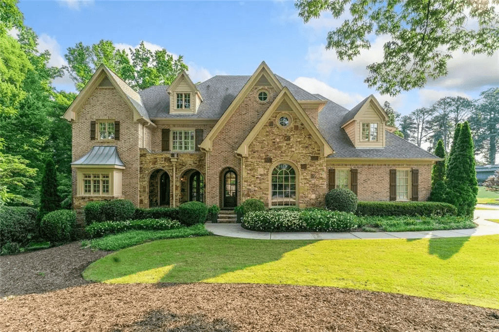 Full exterior home renovation by Brook Realty and Renovations including house and trim painting, window replacement, new deck installation, siding replacement, gutter upgrades, and driveway repairs.